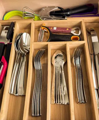 a wooden drawer with utensils in it at Family Mountain Escape - Three Townhouses in One in Canmore