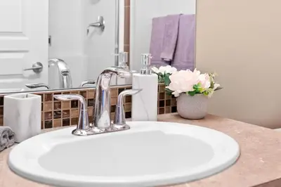 a bathroom sink with a chrome faucet on a counter at GlobalStay Downtown Calgary Condos in Calgary