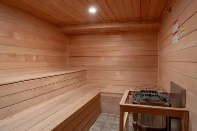 a wooden sauna with a wooden table and a bench at Banff Caribou Lodge and Spa in Banff