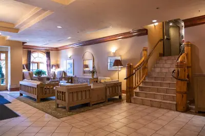 a lobby with a staircase and a living room at Banff Caribou Lodge and Spa in Banff