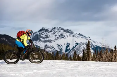 a person riding a bike in the snow at Banff Park Lodge in Banff