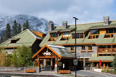a large building with a mountain in the background at Fox Hotel and Suites in Banff