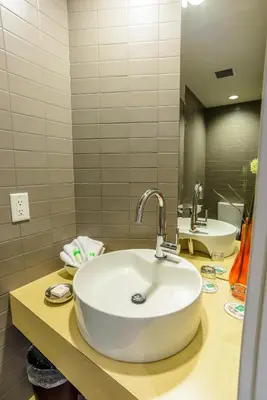 a bathroom with a white sink and a mirror at Bow View Lodge in Banff