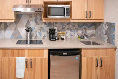 a kitchen with a sink and a microwave at Tunnel Mountain Resort in Banff