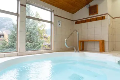 a large bath tub in a bathroom with a window at Red Carpet Inn in Banff