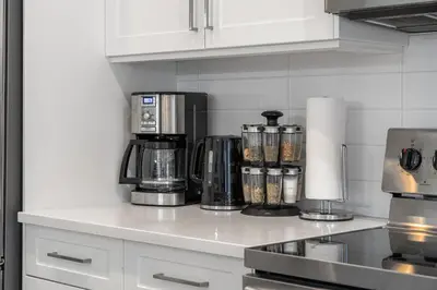 a kitchen counter with a coffee maker on it at Luxury Spacious Private House near City Centre in Calgary