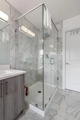a bathroom with a shower with a glass door at Luxury Spacious Private House near City Centre in Calgary