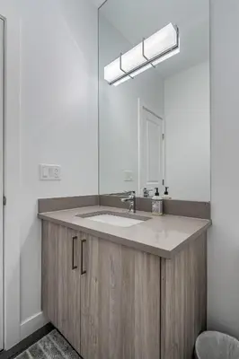 a bathroom with a sink and a mirror at Contemporary Luxury 4 bedroom House near Downtown in Calgary