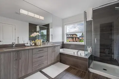 a bathroom with a tub and a sink and a shower at Contemporary Luxury 4 bedroom House near Downtown in Calgary