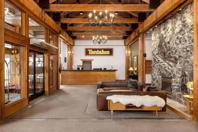 a living room with a couch and a fireplace at Tantalus Resort Lodge in Whistler