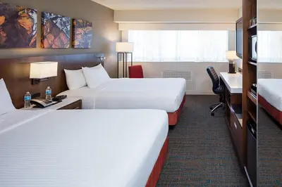 a hotel room with two beds and a desk at Delta Hotels by Marriott Calgary South in Calgary