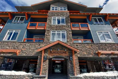 a large building with a sign that reads backstone mountain resort at Blackstone Mountain Lodge by CLIQUE in Canmore