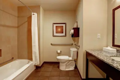 a bathroom with a toilet and a tub and a sink at Hampton Inn by Hilton Chilliwack in Chilliwack