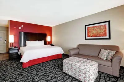 a hotel room with a bed and a couch at Hampton Inn by Hilton Chilliwack in Chilliwack