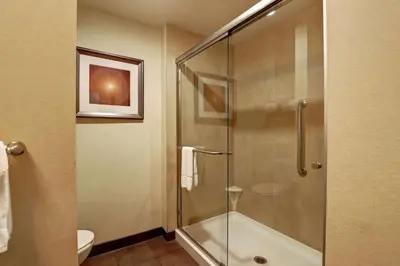 a bathroom with a glass shower with a toilet at Hampton Inn by Hilton Chilliwack in Chilliwack