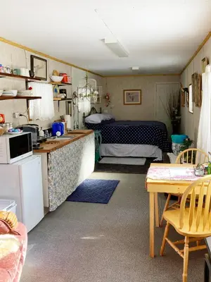 a kitchen and a living room with a bed at Jade City Bungalow in Jade City