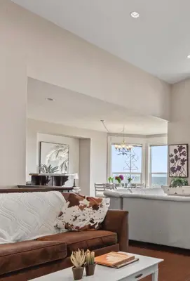 a living room with a large bed and a kitchen at Seaview Executive Home in Ladysmith
