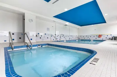 a large swimming pool with a blue ceiling at Best Western Premier Route 97 Vernon in Vernon