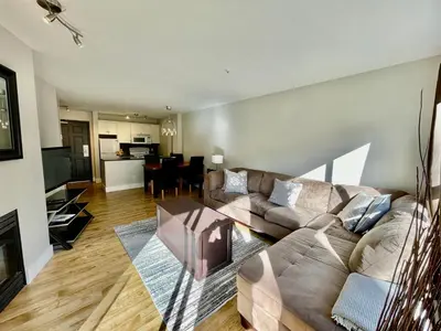 a living room with a couch and a table at Best ski in ski out condo at Whistler in Whistler