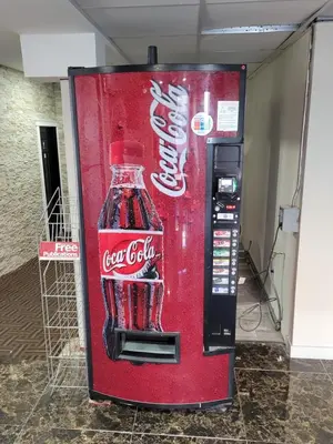 an old coca cola vending machine in a building at Super 8 North Red Deer in Red Deer