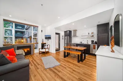 a living room with a couch and a table at Luxury and Modern Studio at Blackcomb base in Whistler