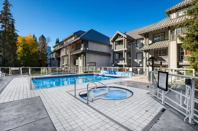 a swimming pool in the middle of a house at Luxury and Modern Studio at Blackcomb base in Whistler