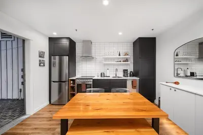 a kitchen with a wooden table in the middle at Luxury and Modern Studio at Blackcomb base in Whistler