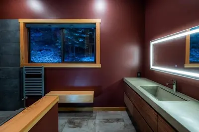 a bathroom with a sink and a window at Luxe Modern Timberframe - Iconic Panorama Views with AC in Nelson