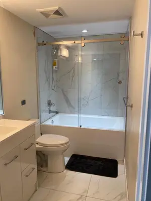 a bathroom with a tub and a toilet and a shower at Beautiful Bright with water view AC DT 2BR 2BTh 3BD sleeps 6 guests in Vancouver