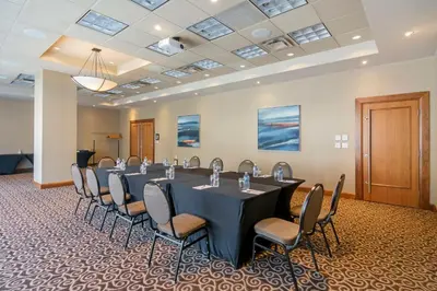 a conference room with a long table and chairs at Best Western Premier Chateau Granville Hotel & Suites & Conference Centre in Vancouver