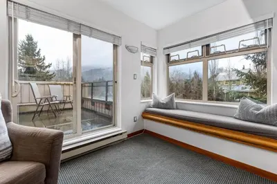 a window seat in a room with two windows at 1BR in Lake Placid Lodge, Steps to Creekside Gondola, Shared Pool and Hot Tub, Lounge Access in Whistler