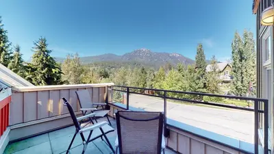 a balcony with chairs and a view of the mountains at 1BR in Lake Placid Lodge, Steps to Creekside Gondola, Shared Pool and Hot Tub, Lounge Access in Whistler