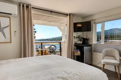 a bedroom with a bed and a large window at Manana Resort and Marina in Ladysmith