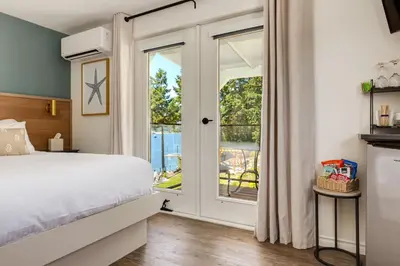 a bedroom with a bed and a sliding glass door at Manana Resort and Marina in Ladysmith