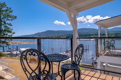 a balcony with two chairs and a table with a view at Manana Resort and Marina in Ladysmith