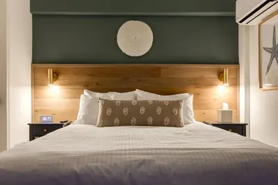 a bedroom with a large bed with a green headboard at Manana Resort and Marina in Ladysmith