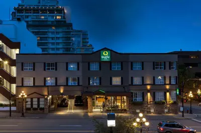 a building with a green sign on the front of it at Quality Inn Downtown Inner Harbour in Victoria