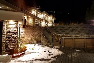 a house with snow in the yard at night at Honeymoon Suite in West Kelowna