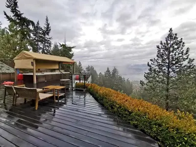 a wooden deck with a table and a tent at Honeymoon Suite in West Kelowna