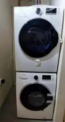 a washing machine with a sink on top of it at Honeymoon Suite in West Kelowna