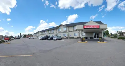a hotel inn with a parking lot in front of it at Westlake Inn in Strathmore