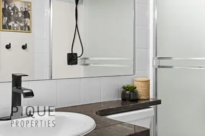 a bathroom with a sink and a refrigerator at Mystic Mountain Chalet, Heated Outdoor Pool & Hot Tub, Free Parking, Fast Wifi! in Canmore