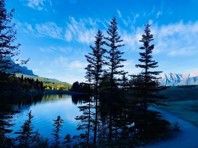 a view of a lake with trees and mountains at Hotel Room in Windtower Lodge-121 in Canmore