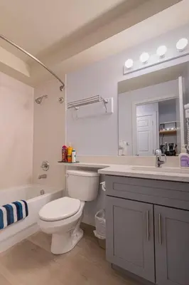 a bathroom with a toilet and a sink and a mirror at Hotel Room in Windtower Lodge-121 in Canmore