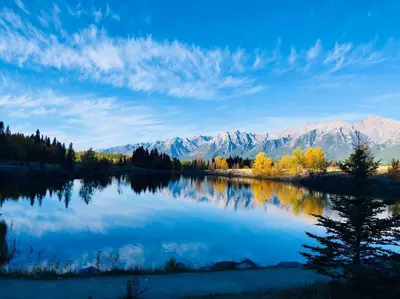 a view of a lake with mountains in the background at Hotel Room in Windtower Lodge-121 in Canmore