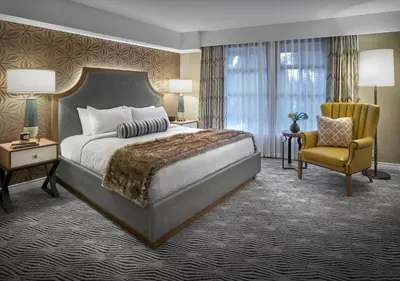 a hotel room with a bed and a chair at Sun Peaks Grand Hotel & Conference Centre in Sun Peaks