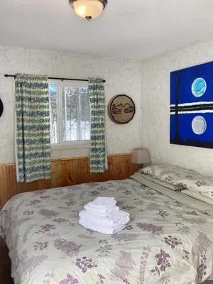 a bedroom with a bed with towels on it at Jade City Motel in Jade City