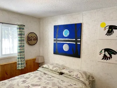 a bedroom with a bed and a picture on the wall at Jade City Motel in Jade City