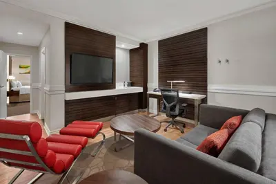 a living room with a couch and a desk at Delta Hotels by Marriott Edmonton Centre Suites in Edmonton