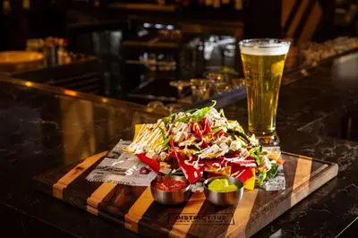 a plate of food and a glass of beer at Delta Hotels by Marriott Edmonton Centre Suites in Edmonton